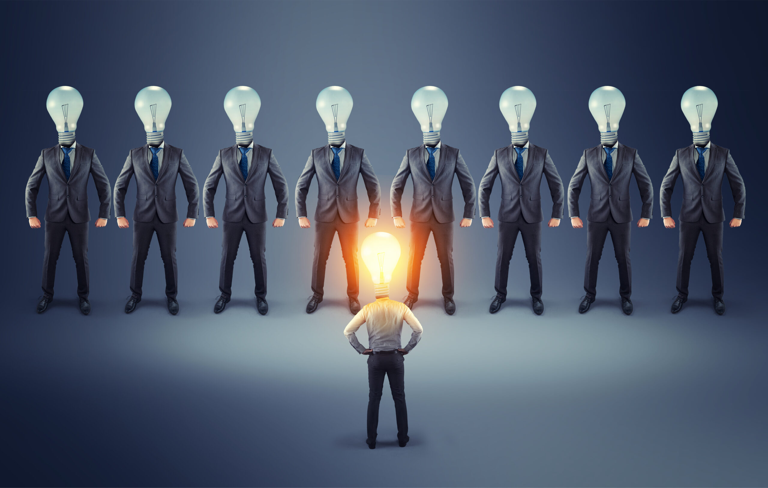 Businessman,With,Lit,Lightbulb,Instead,Of,A,Head,Standing,In